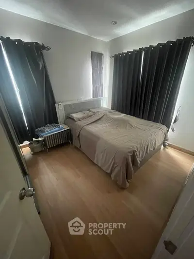 Cozy bedroom with natural light and elegant dark curtains