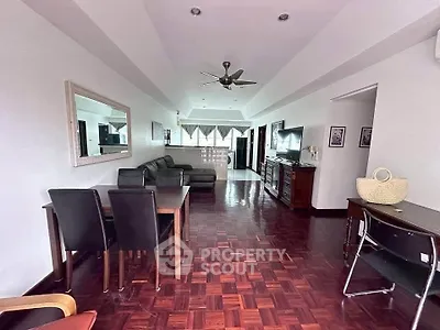 Spacious living room with elegant parquet flooring and modern furniture in a stylish apartment.