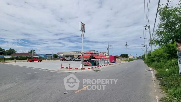 Spacious corner lot with convenience store and ample parking space.