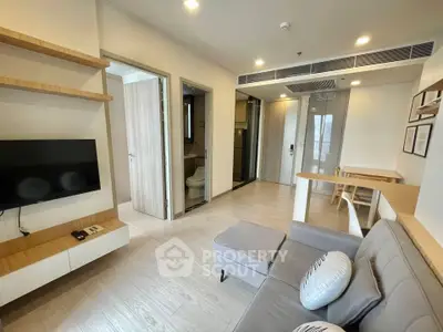 Modern living room with sleek furniture and open layout in a stylish apartment.