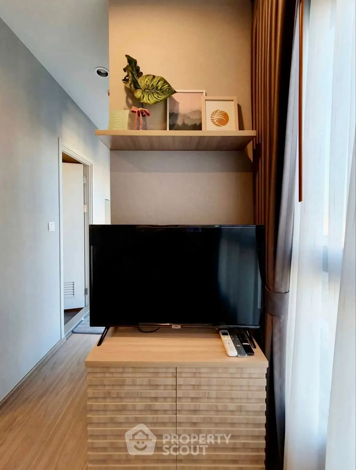 Modern living room with stylish TV setup and decorative shelving