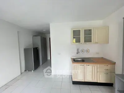 Spacious kitchen with modern cabinetry and sleek appliances in a bright, open layout.