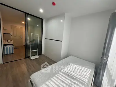 Modern bedroom with sliding glass doors and ample natural light