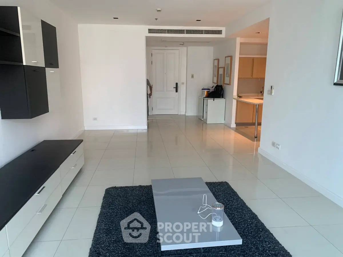 Spacious modern living room with sleek furniture and open layout in a contemporary apartment.