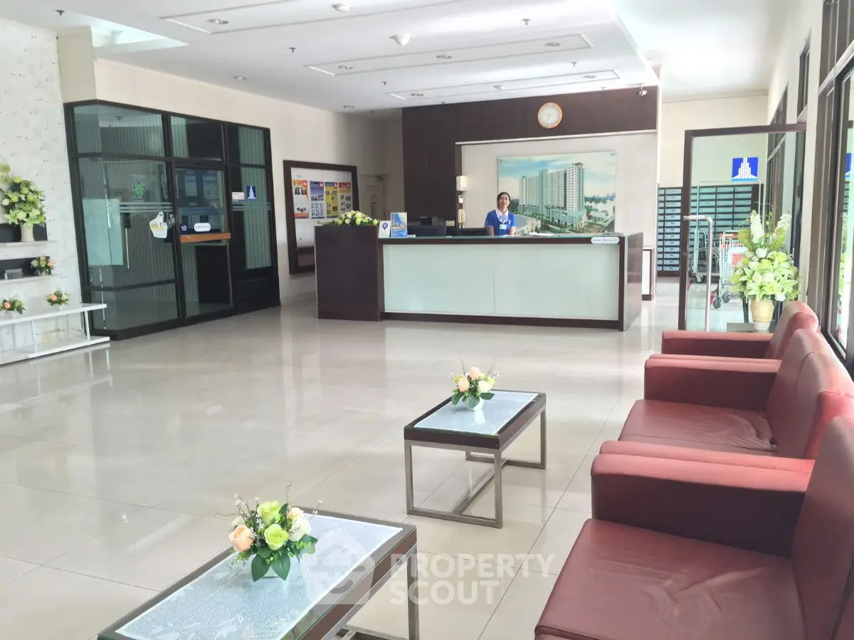 Spacious and elegant building lobby with modern decor and comfortable seating.