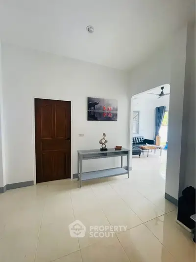 Spacious entryway leading to a bright living room with modern decor