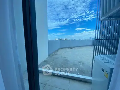 Spacious balcony with stunning city view and clear blue sky