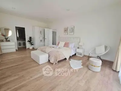 Spacious and elegant bedroom with modern decor and wooden flooring