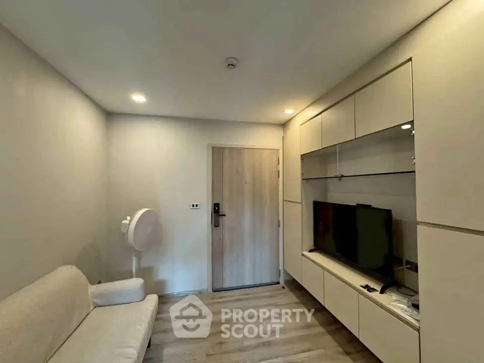 Modern living room with sleek built-in storage and cozy seating area.