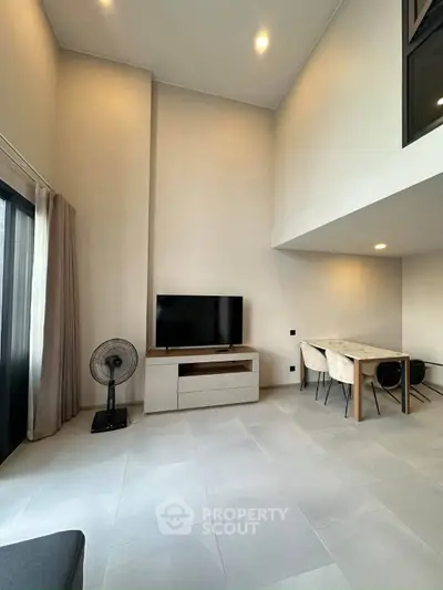 Spacious modern living room with high ceilings and elegant dining area