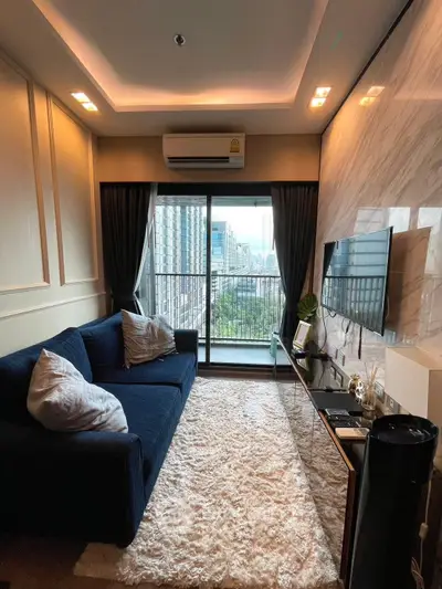 Stylish living room with city view, modern decor, and cozy ambiance in urban apartment.