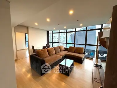 Spacious modern living room with large windows and city view