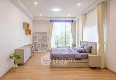 Spacious modern bedroom with large windows and stylish decor