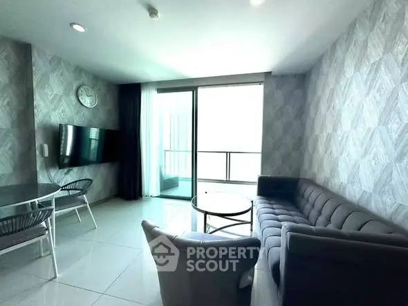 Modern living room with stylish furniture and balcony access