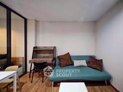Modern living room with stylish sofa and wooden flooring, perfect for cozy urban living.