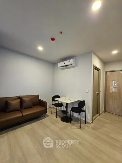 Modern living room with sleek furniture and air conditioning in a stylish apartment.