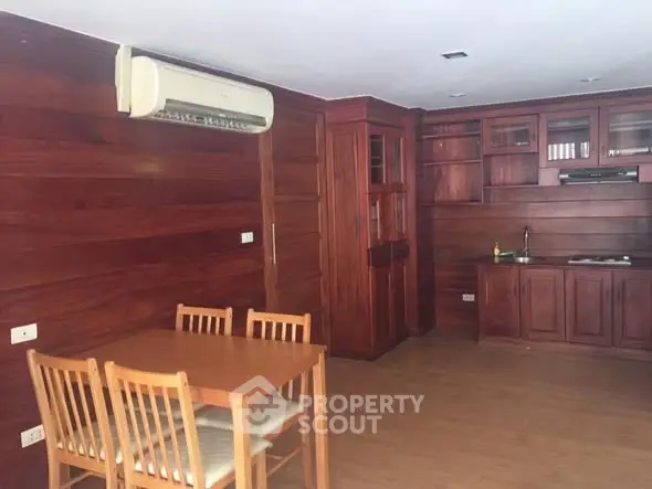 Cozy wooden interior kitchen with dining area and air conditioning