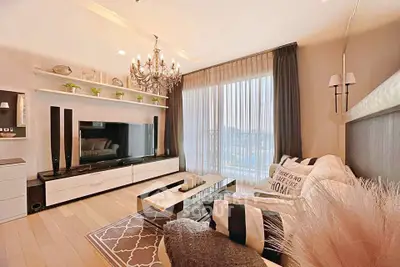 Luxurious modern living room with elegant chandelier and large TV setup