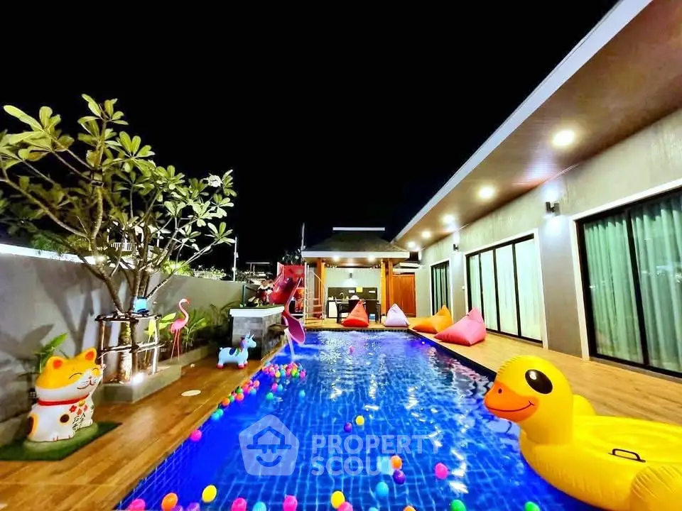 Luxurious modern villa with private pool and vibrant night lighting, perfect for relaxation and entertainment.