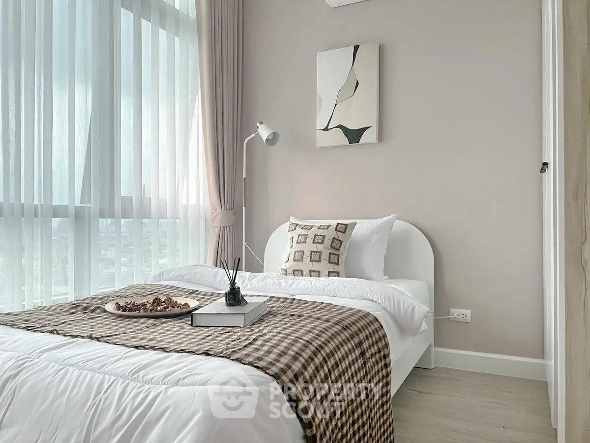 Cozy modern bedroom with large window and stylish decor