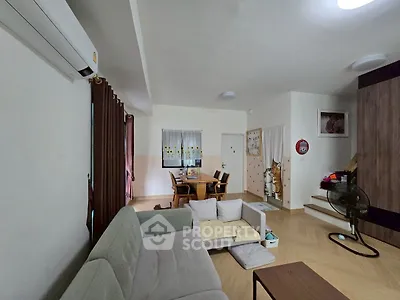 Cozy living room with modern furniture and dining area, perfect for family gatherings.