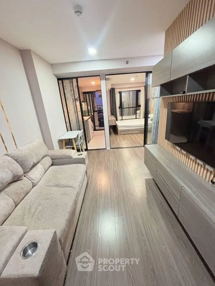 Modern living room with sleek design and open view to bedroom