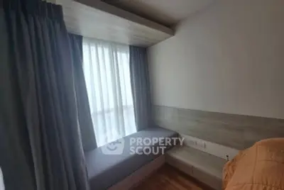 Cozy bedroom with built-in window seat and modern design.