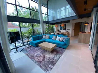 Stunning modern living room with large windows and vibrant blue sofa