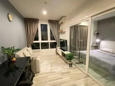 Modern apartment interior with cozy living room and adjacent bedroom, featuring stylish decor and natural light.