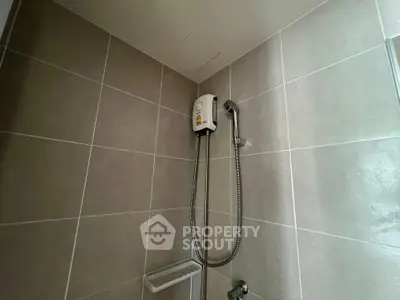 Modern bathroom shower with sleek tiles and water heater