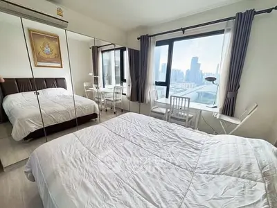 Spacious bedroom with mirrored closet and city view in modern apartment