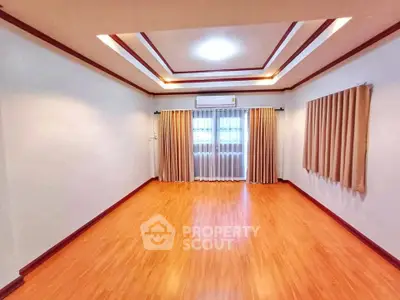 Spacious empty living room with wooden flooring and modern ceiling design