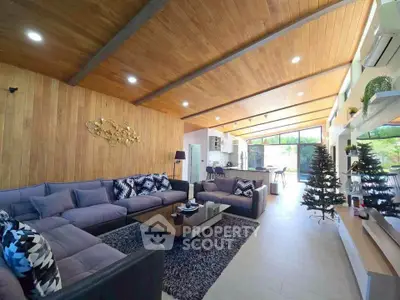 Spacious modern living room with wooden ceiling and large windows