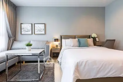 Modern bedroom with cozy seating area and elegant decor