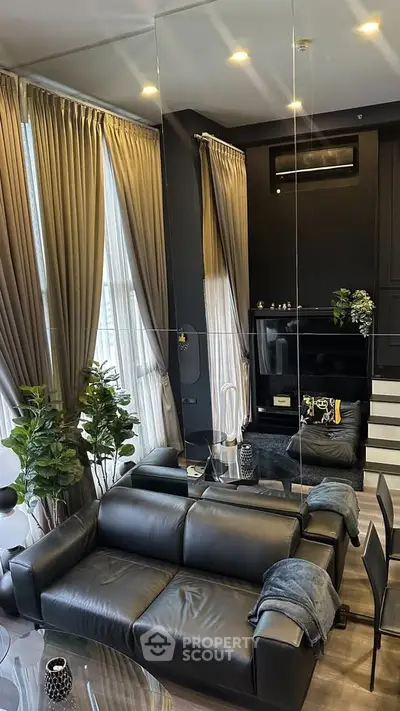 Luxurious modern living room with black leather sofa and elegant decor