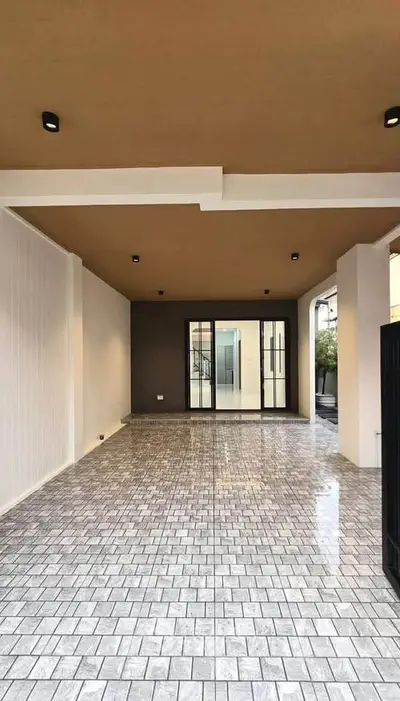 Spacious modern entrance with elegant tiled flooring and sleek lighting
