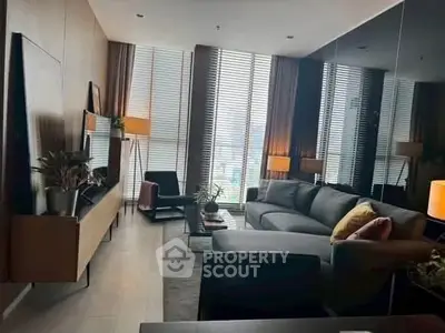 Modern living room with stylish furniture and large windows offering natural light.