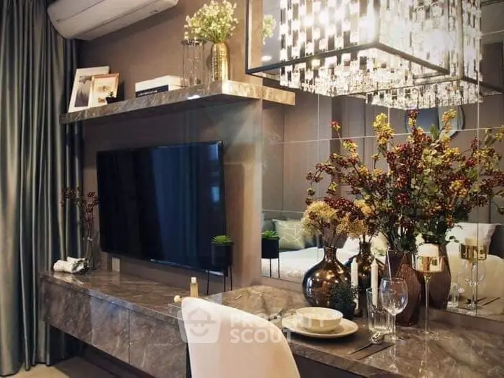 Luxurious living room with elegant decor, featuring a wall-mounted TV, stylish chandelier, and decorative plants.