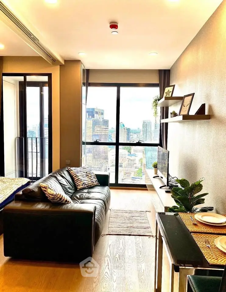 Modern living room with city view, featuring sleek furniture and stylish decor, perfect for urban living.