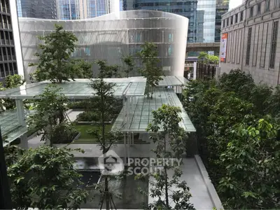 Modern urban garden with lush greenery and sleek architecture in a city setting.