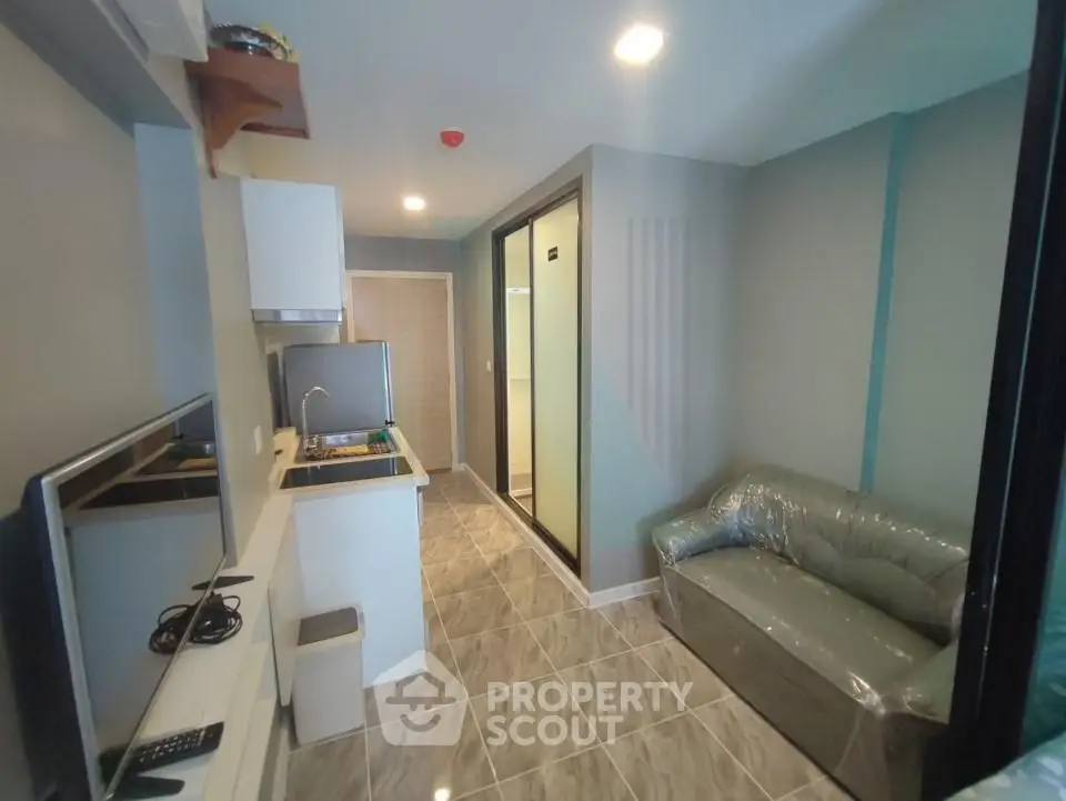 Modern compact living room with kitchenette in a stylish apartment