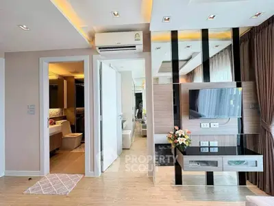 Modern living room with stylish decor and open bathroom view, featuring elegant lighting and sleek flooring.
