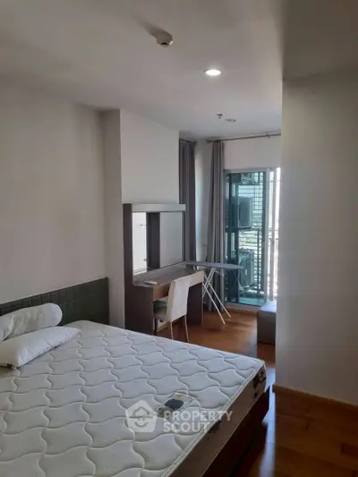 Modern bedroom with balcony access and stylish furniture