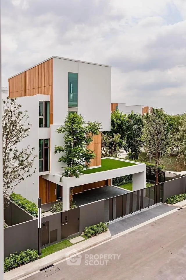 Modern architectural masterpiece with sleek design and lush greenery in a serene neighborhood.