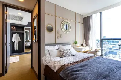 Luxurious bedroom with city view, elegant decor, and ample natural light in modern apartment.