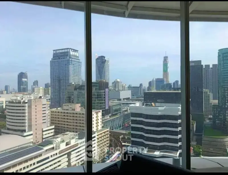 Stunning cityscape view from high-rise building window showcasing urban skyline.