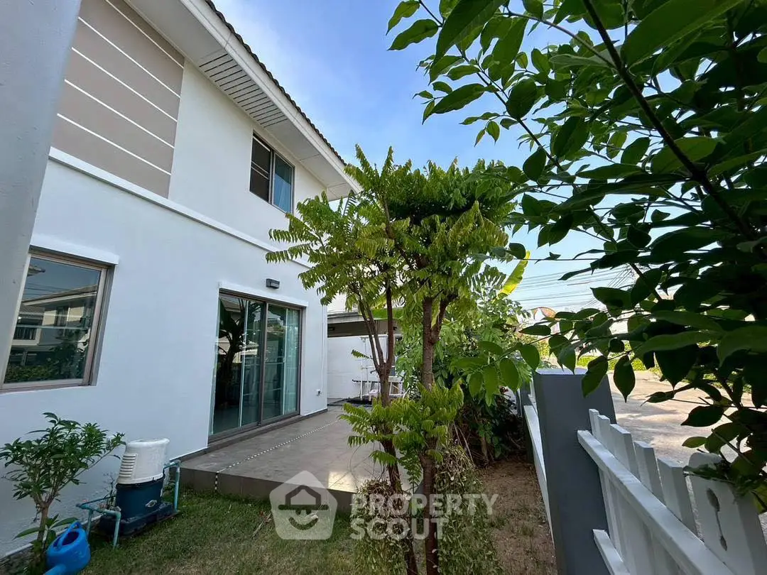 Charming suburban home with lush garden and spacious patio, perfect for outdoor relaxation.