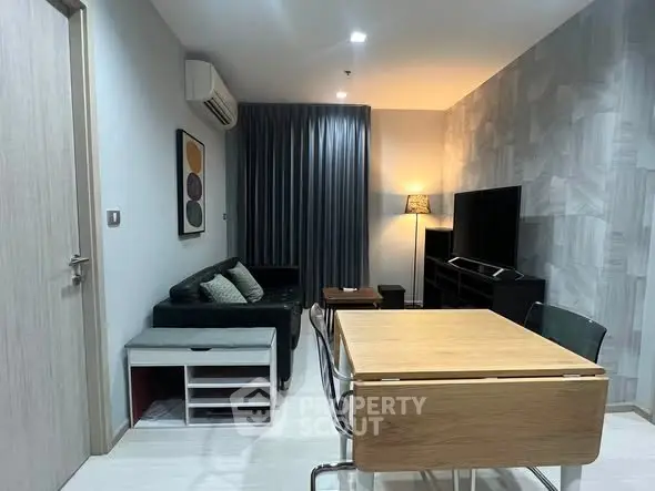 Modern living room with stylish decor, featuring a cozy sofa, dining table, and wall-mounted TV for ultimate comfort.