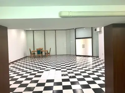 Spacious interior with checkered flooring and modern dining area