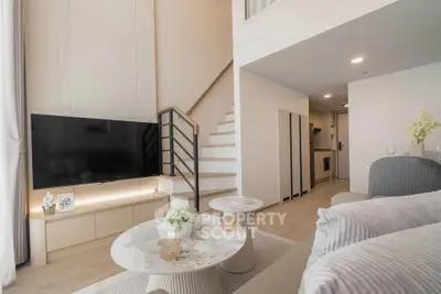 Modern duplex living room with stylish decor and elegant staircase